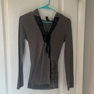 Hooded shirt with lace trim and velvet designs on bottom left and back of shirt